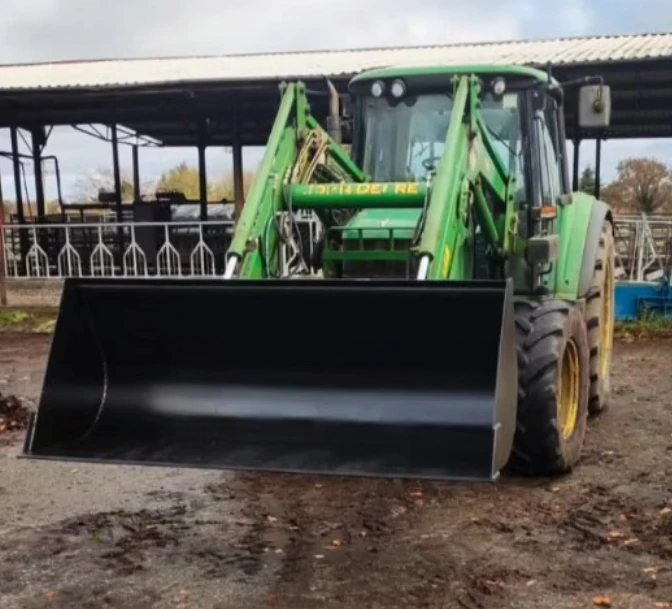 New 7ft black tractor loader bucket on a John Deere tractor